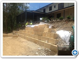 Blocks being fitted for a retaining wall on the Gold Coast