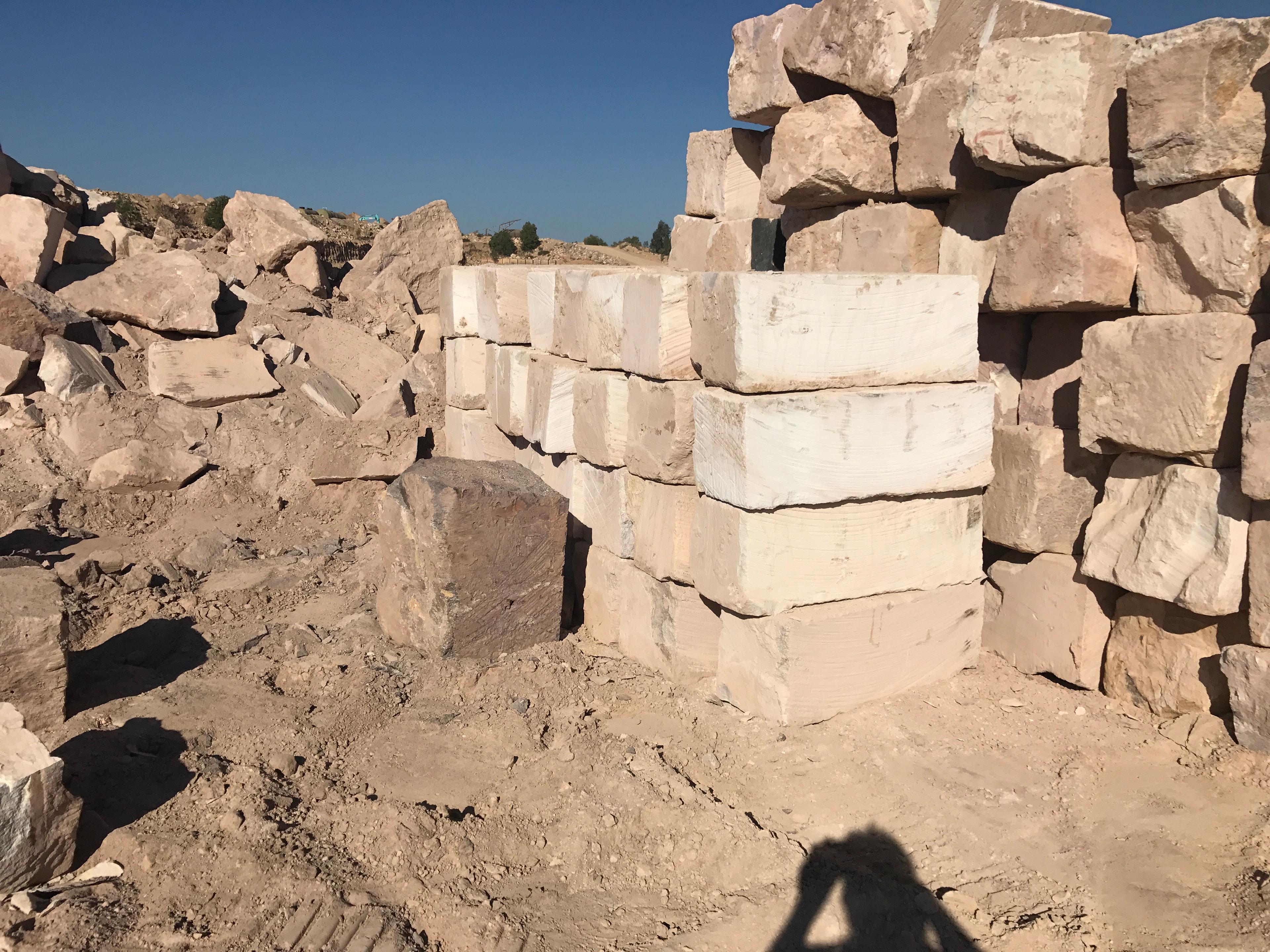 Stacked sandstone and limestone blocks at quarry site