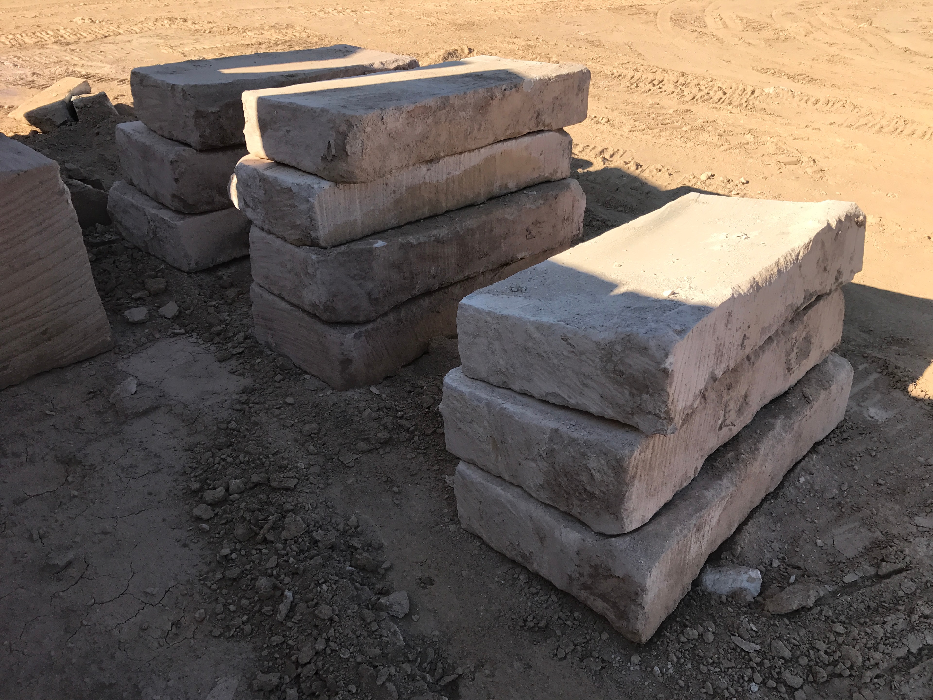 Small stacked sandstone blocks on sandy quarry ground