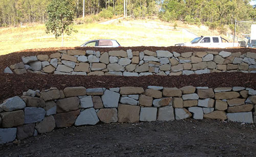 Sandstone rock retaining wall built as a feature for a Gold Coast property at Reedy Creek